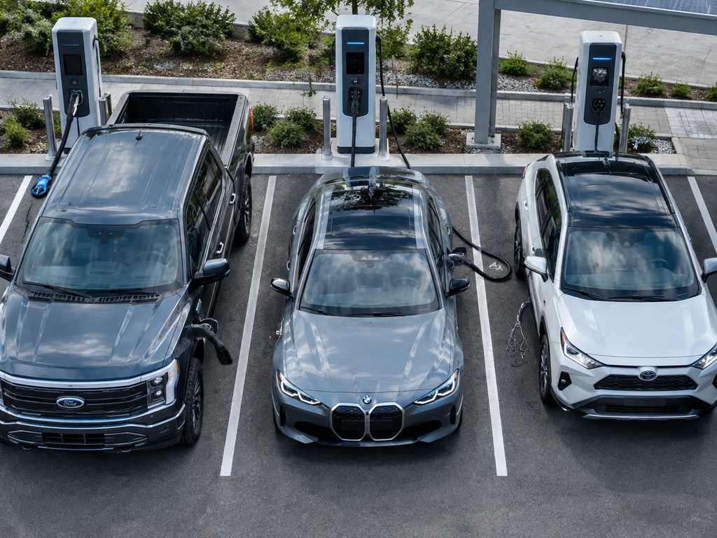 Three EVs charging side by side showing different connector types CCS1 CCS2 Type 2